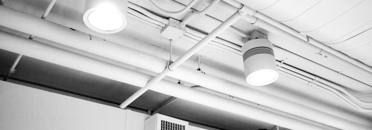 Clean air ducts in a well-lit and clean building hallway