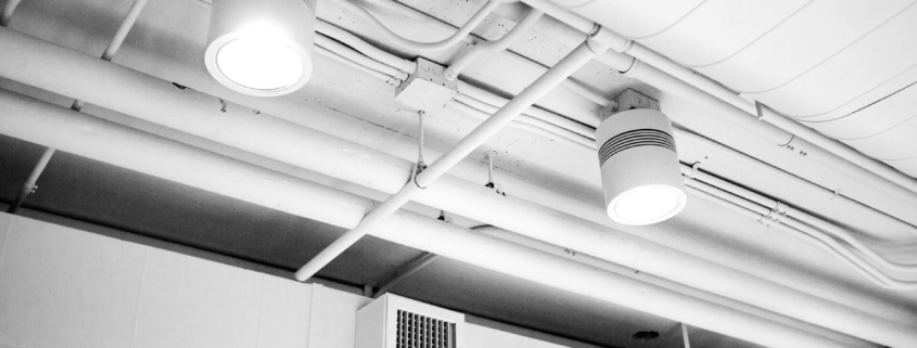 Clean air ducts in a well-lit and clean building hallway