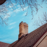 A Chimney with ciimney damage on top of a house