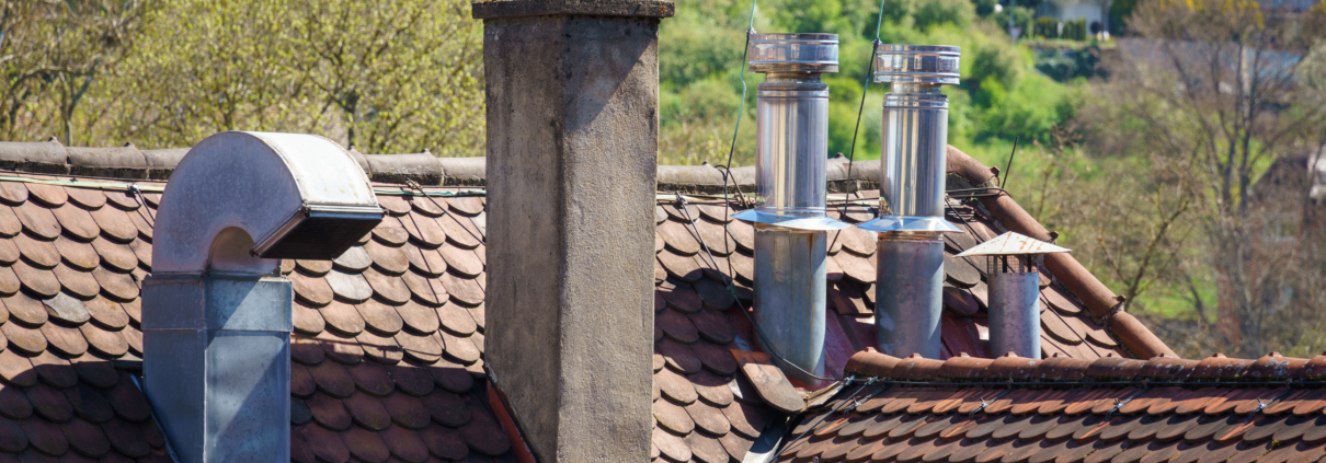 An image of a roof with different chimneys