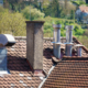 An image of a roof with different chimneys