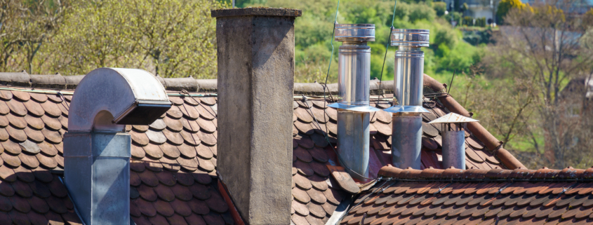 An image of a roof with different chimneys