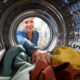 View Looking Out From Inside Dryer Machine As Young Woman Does Laundry