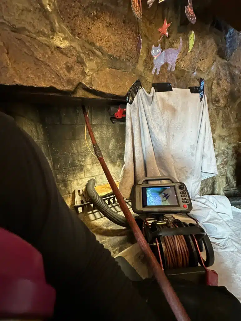 A rocky basement in Woodbridge, VA, with a generator, coiled cable, and damp rock walls.
